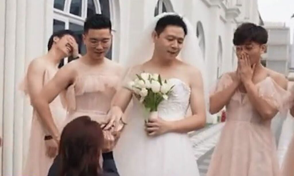 Groom and his best men wear dresses on a special role-reversal wedding