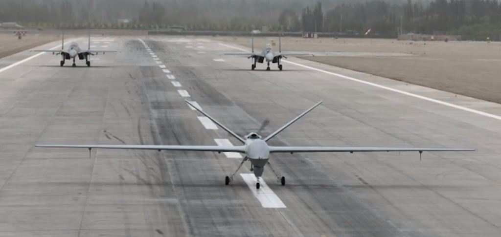 PLA Air Force holds integration training with fighter jets, armed recon drone